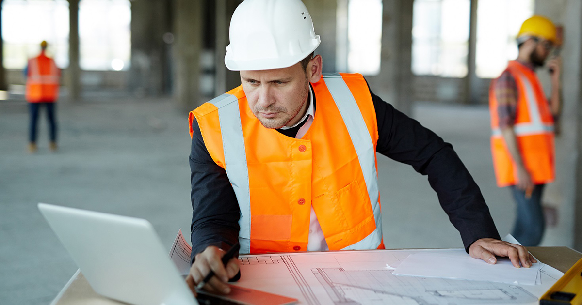 construction worker with computer and plan