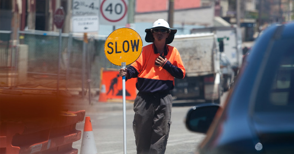 traffic controller with hat and stop slow bat